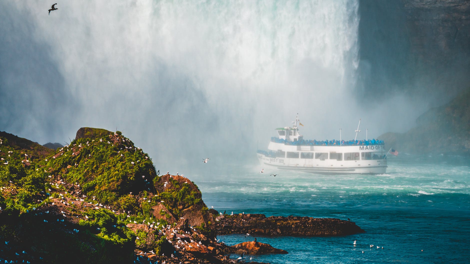 photo of ship near waterfalls