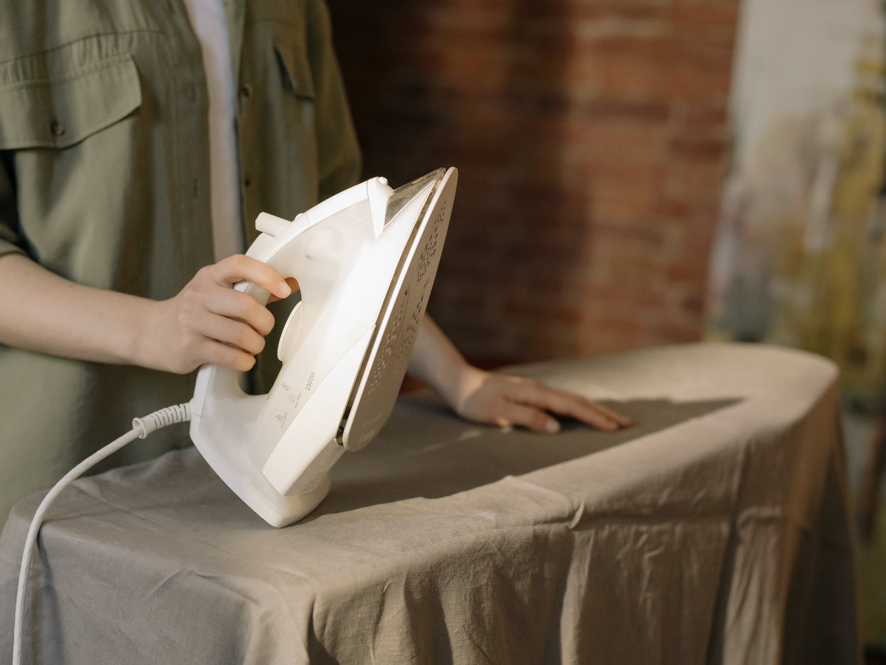 person in gray dress shirt holding white book