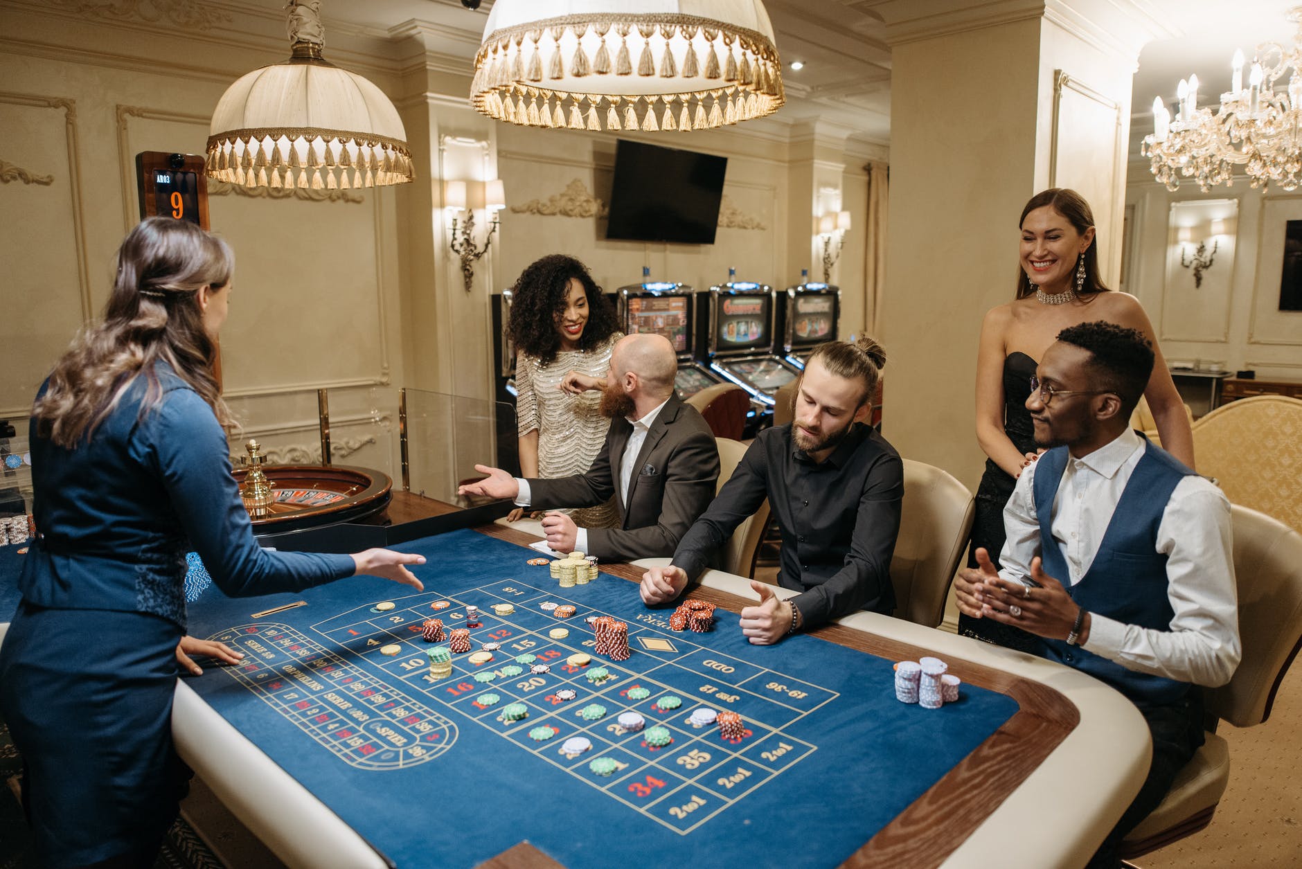 group of gamblers playing on roulette table