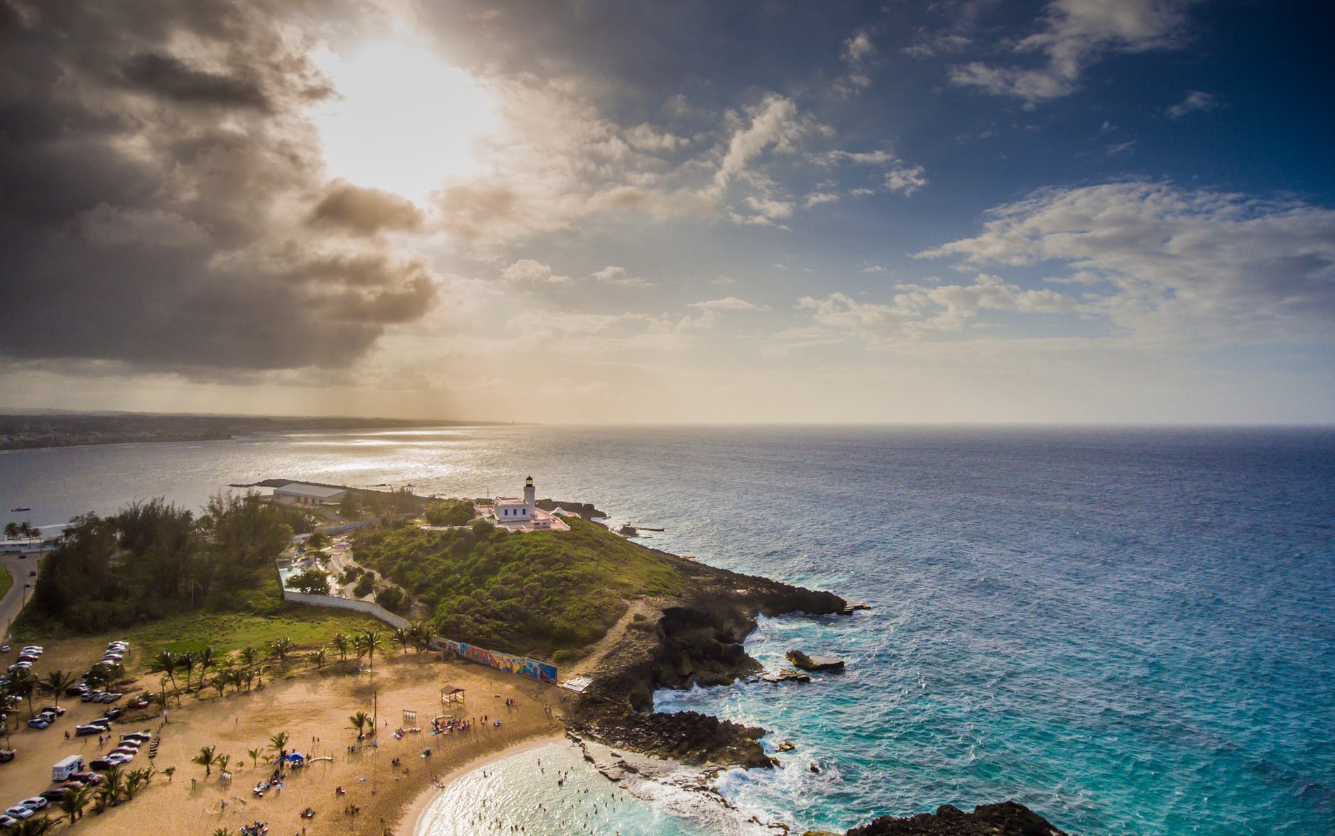 island and ocean under a cloudy sky