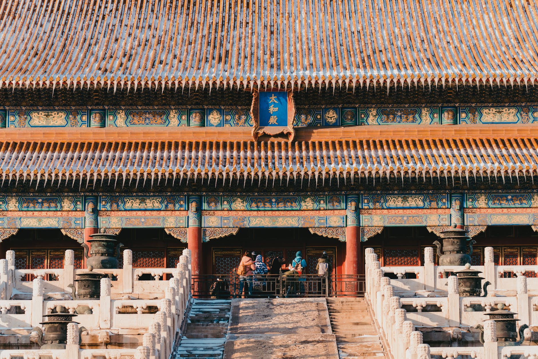 group of people visiting chinese ancient building in winter