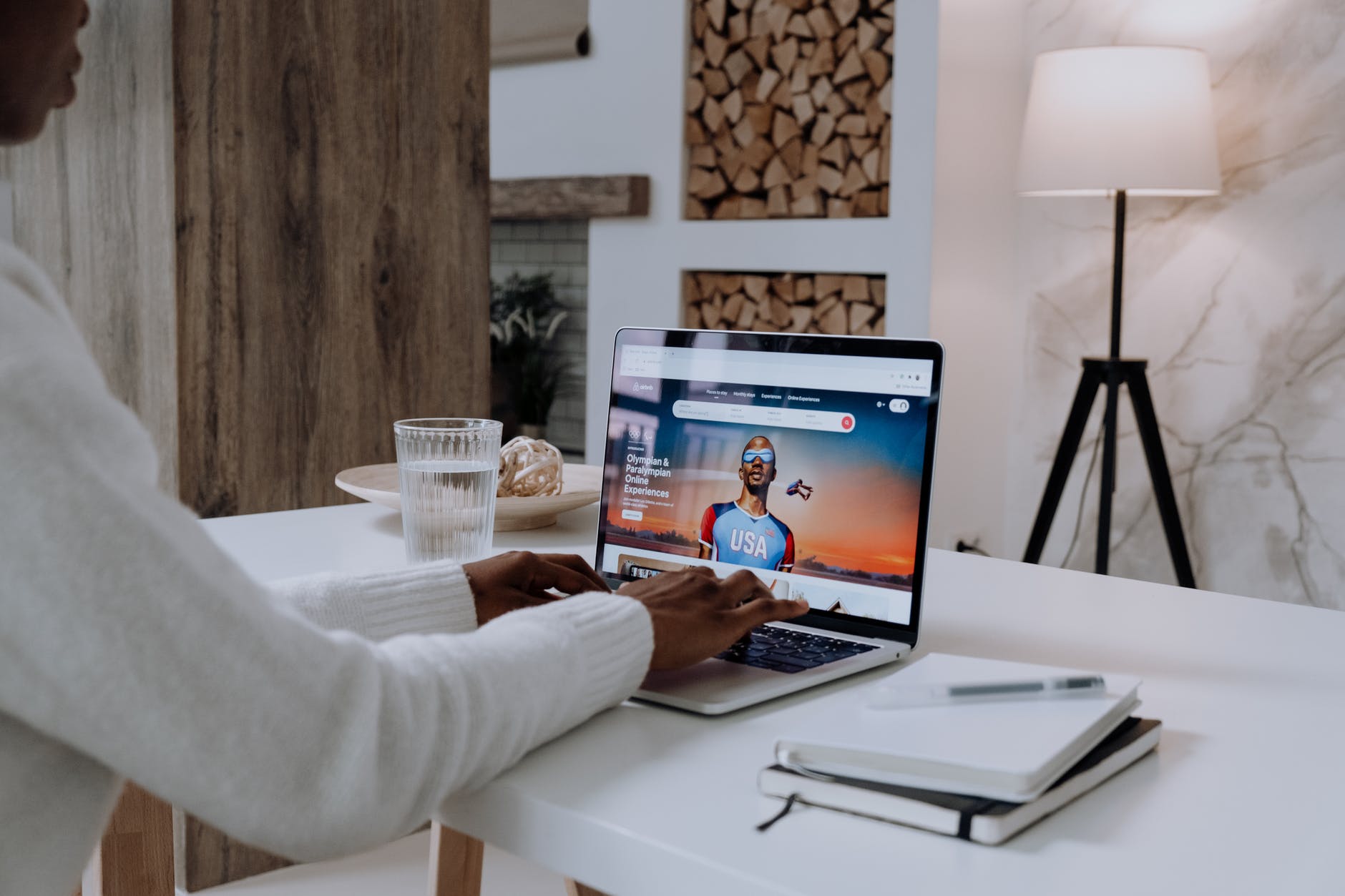 person in white long sleeve shirt using macbook pro