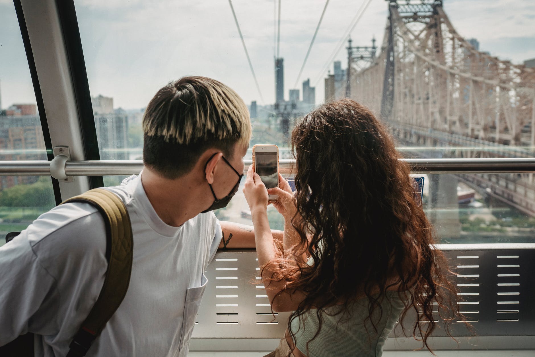 couple riding on ropeway while travelling together