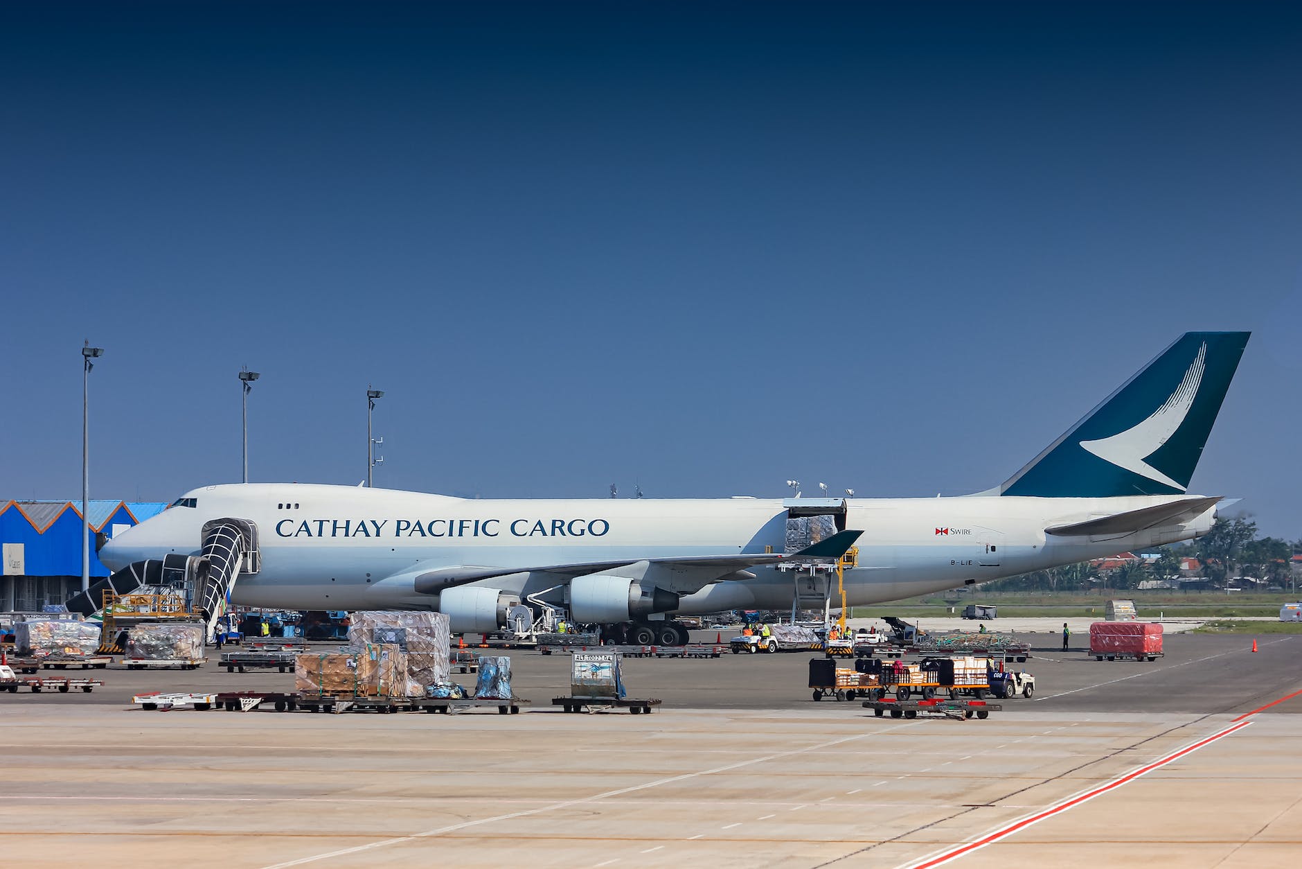 a white and blue airplane on airport