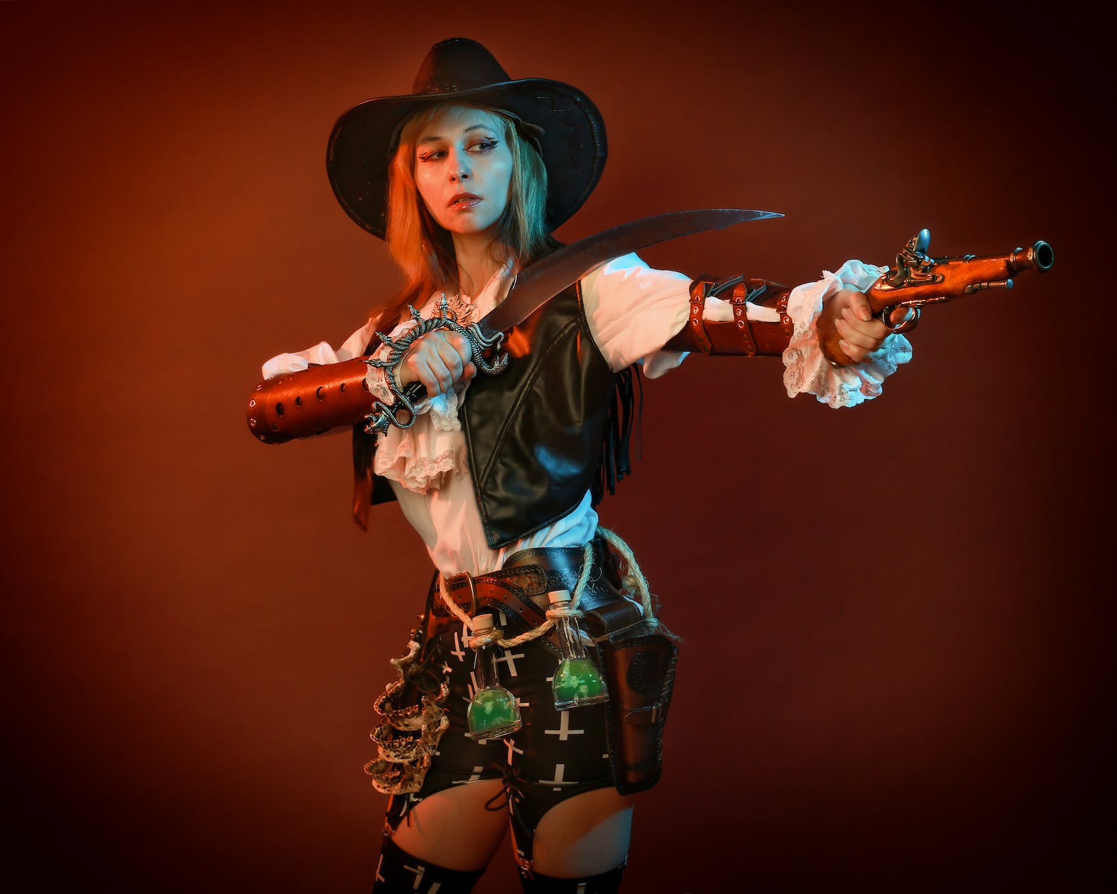 woman in black cowboy hat holding brown and black rifle