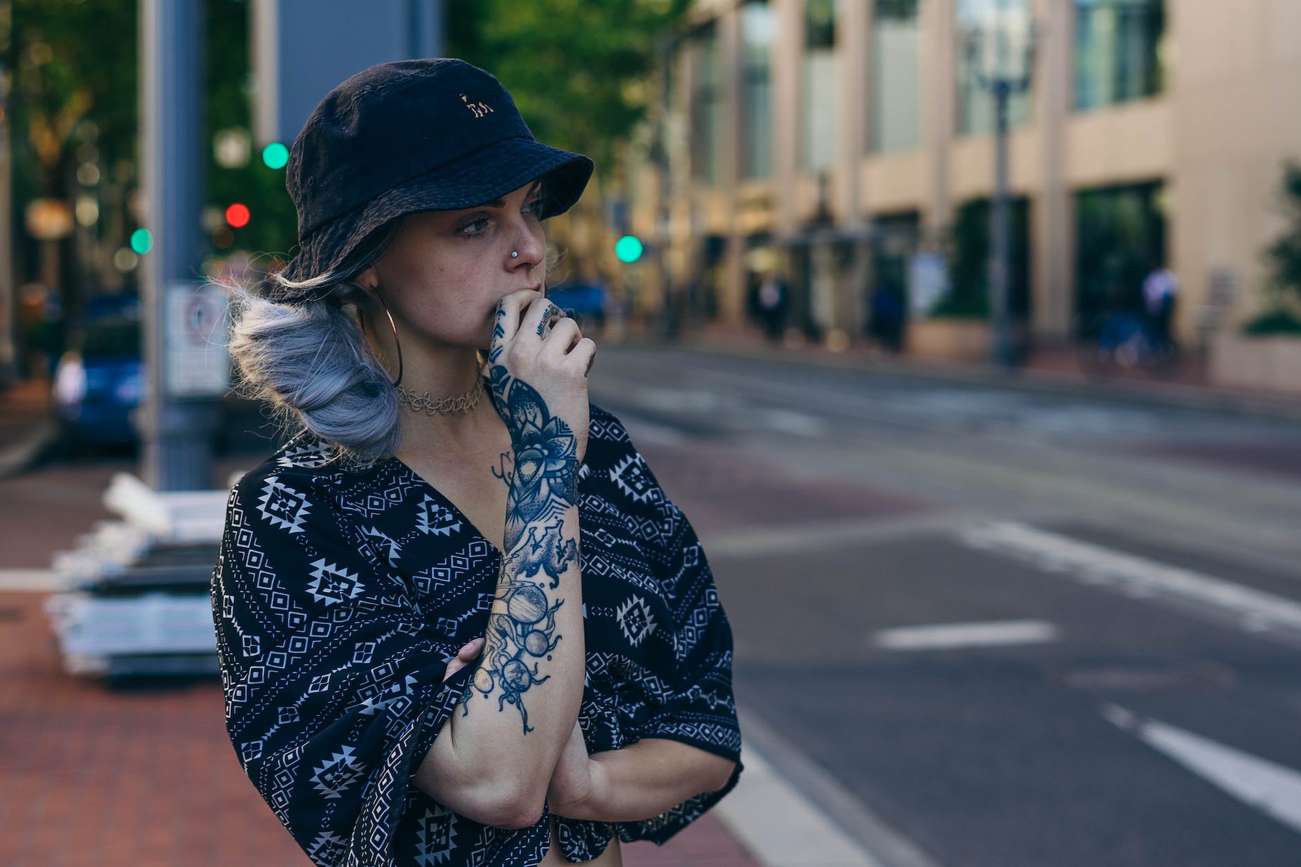 photo of Short hair woman with hats & tattoo