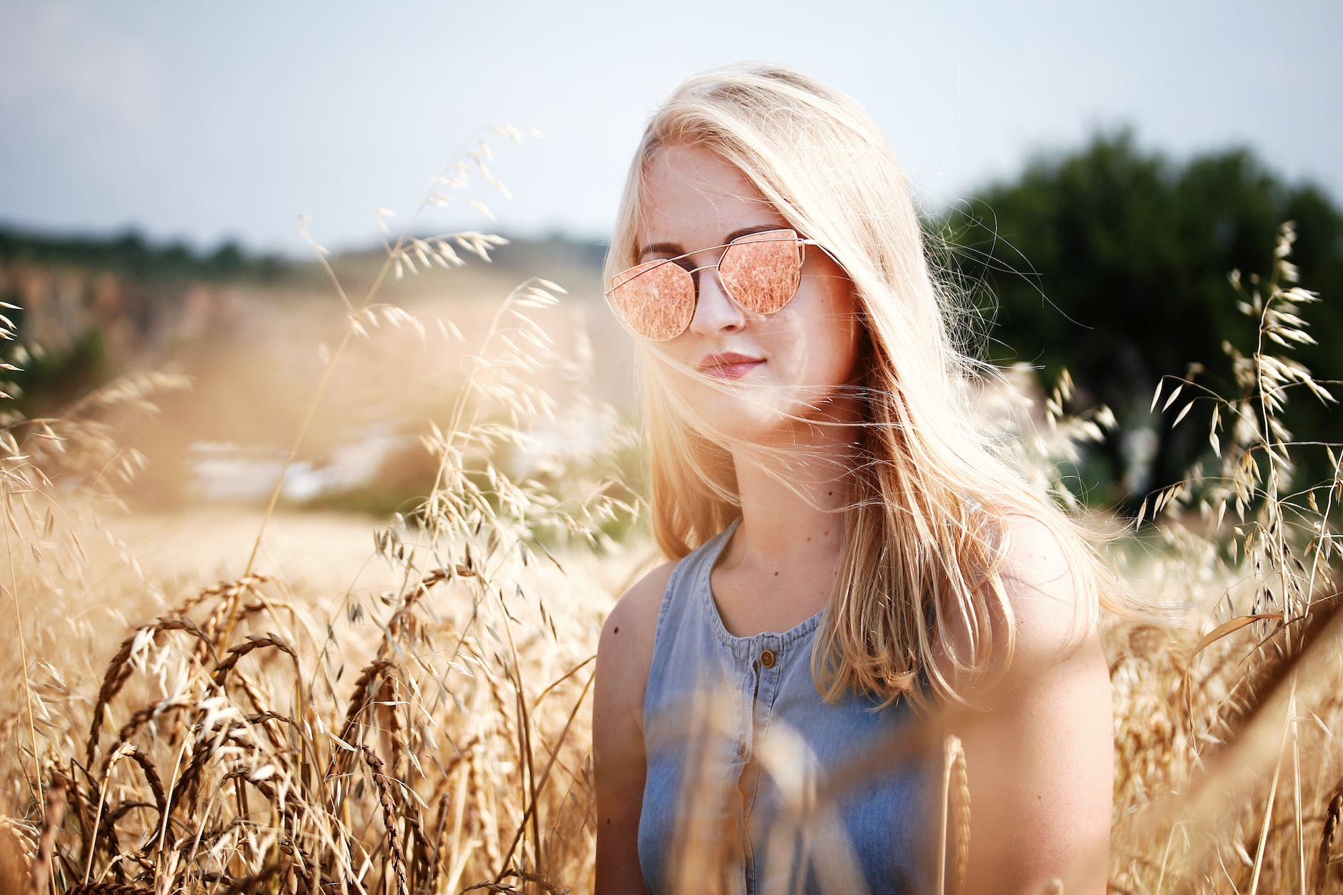 woman in wheat field with Rose Gold Sunglasses