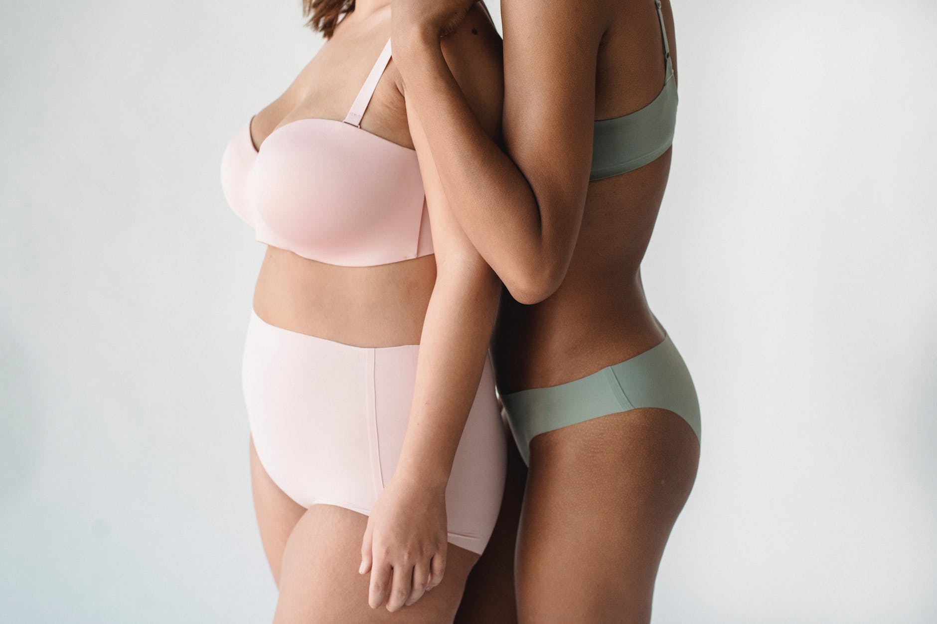 mid section of two women in pastel underwear